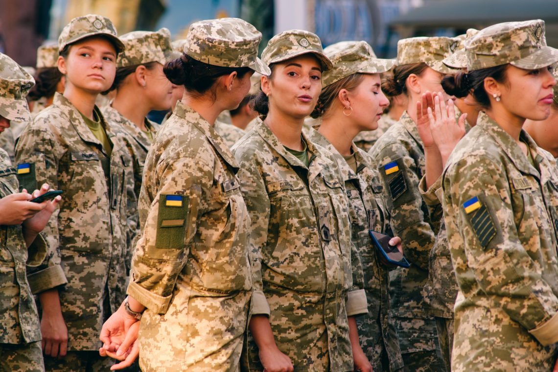 Kyiv, Ukraine – August 20, 2021: Rehearsal of the military parade on occasion of 30 years Independence Day of Ukraine. Young smiling women in military camouflage uniform on Khreshchatyk street