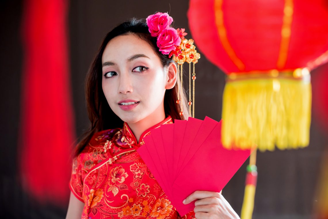 Happy chinese new year. Asian woman holding red envelope