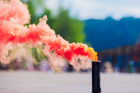colorful red smoke bombs in action