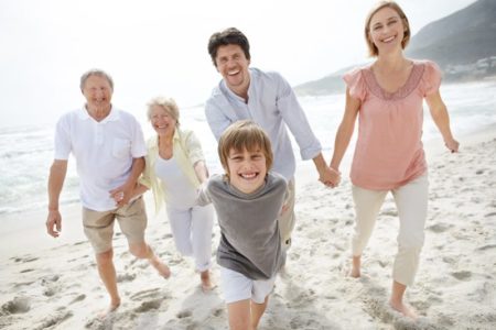 Happy family walking on the beach - Outdoor