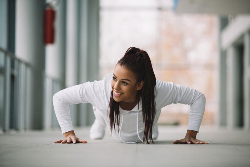 Nebojsa Tatomirov stock photography - Front view of young fit girl doing pushups