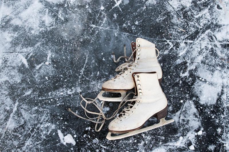 Old womans ice skates on the ice.
