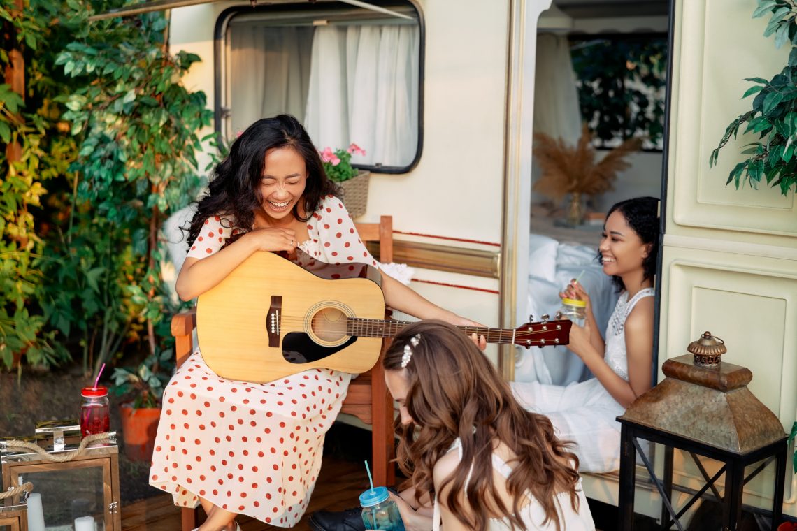 Laughing happy women with guitar