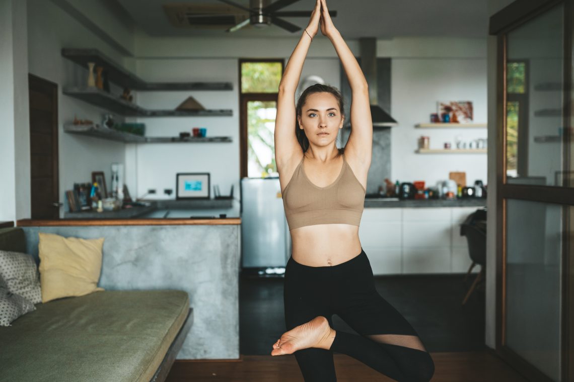 Woman practicing home yoga stock photo