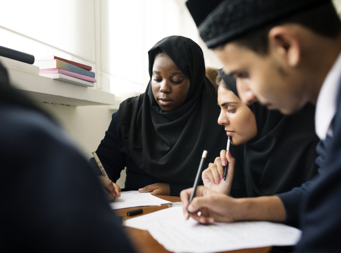 Diverse Muslim children studying in classroom stock photo