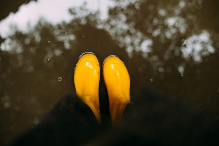 stock photography Yellow rubber boots in the water.