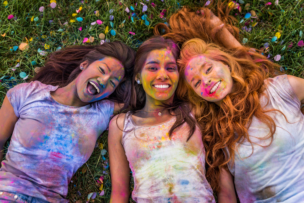 Фотографія три дівчини на фестивалі кольорів холі