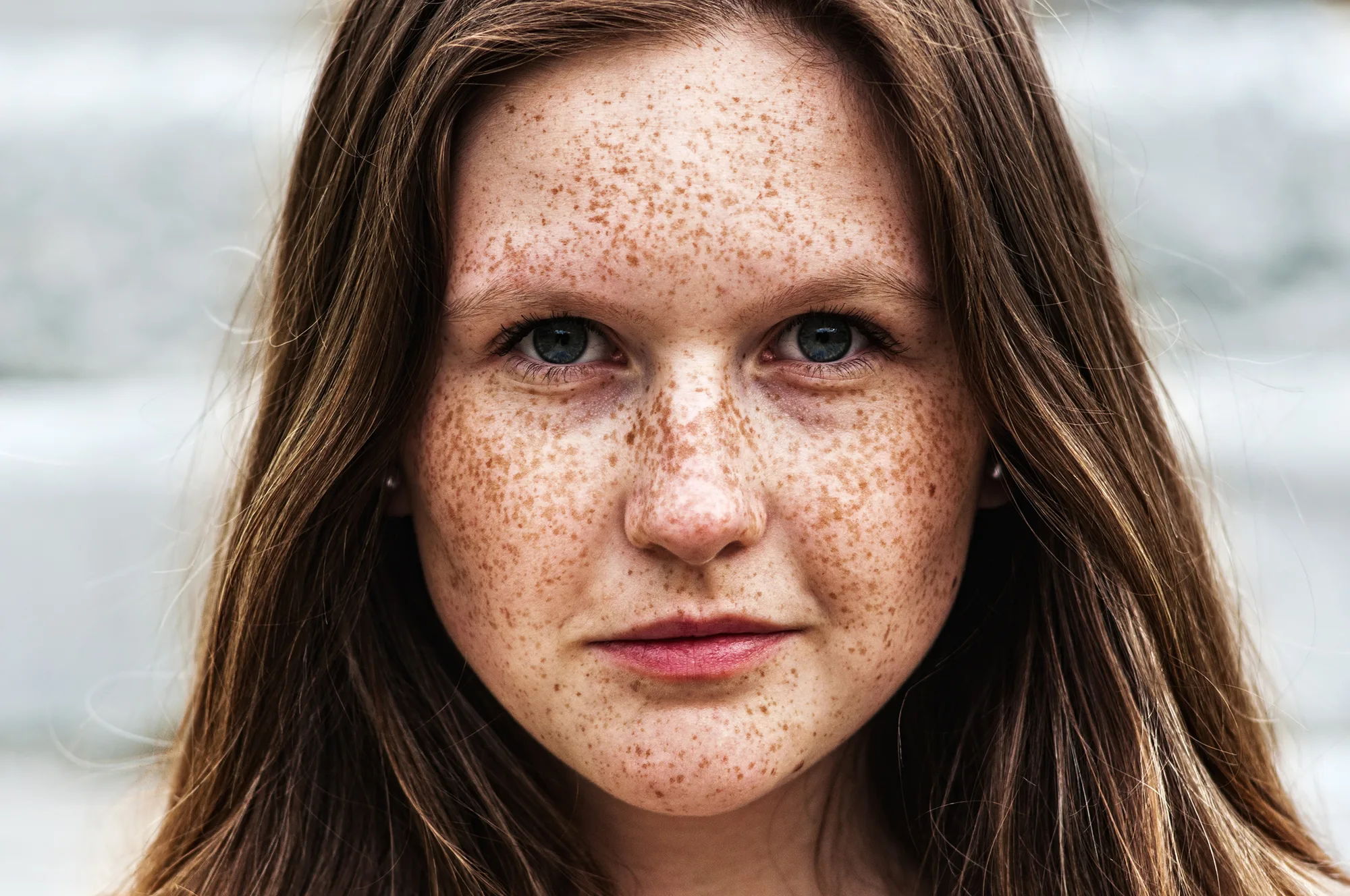 Portrait of a beautiful girl with freckles, close-up
