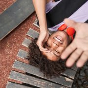 Top view of the overjoyed curly boy laughing out loud - stock photo