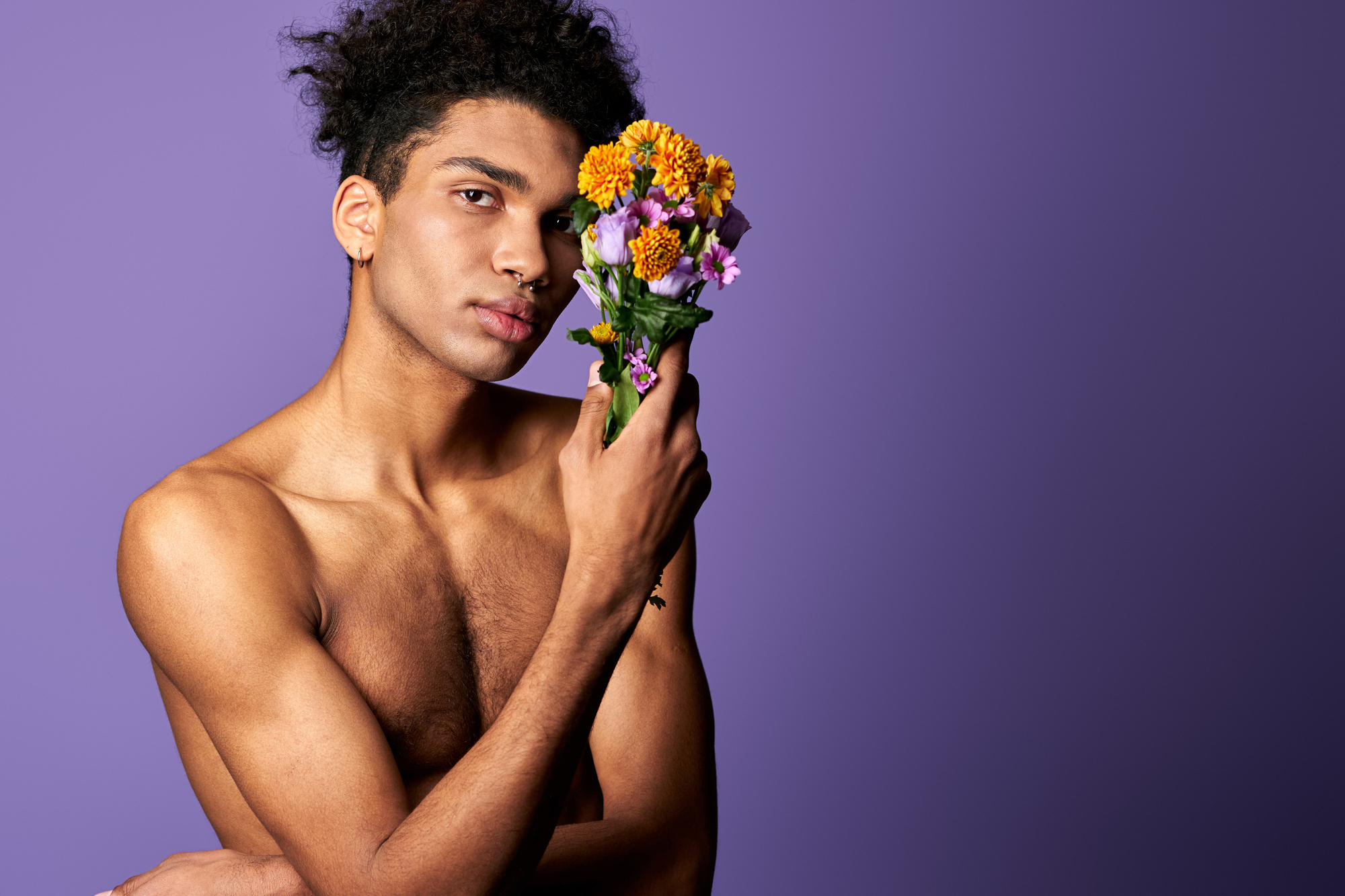 Nacked hispanic man with flowers - poses for portrait photography