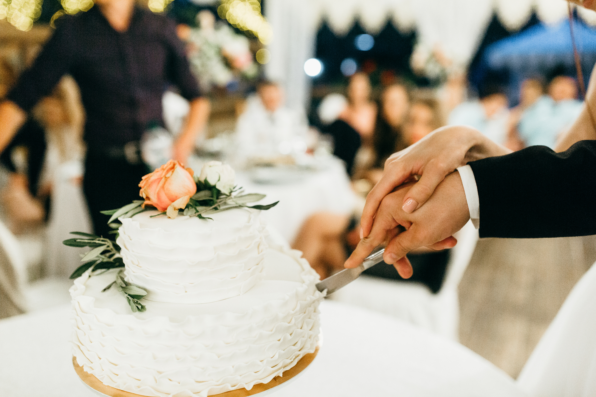 Couple cutting beautiful wedding cake - stock photo