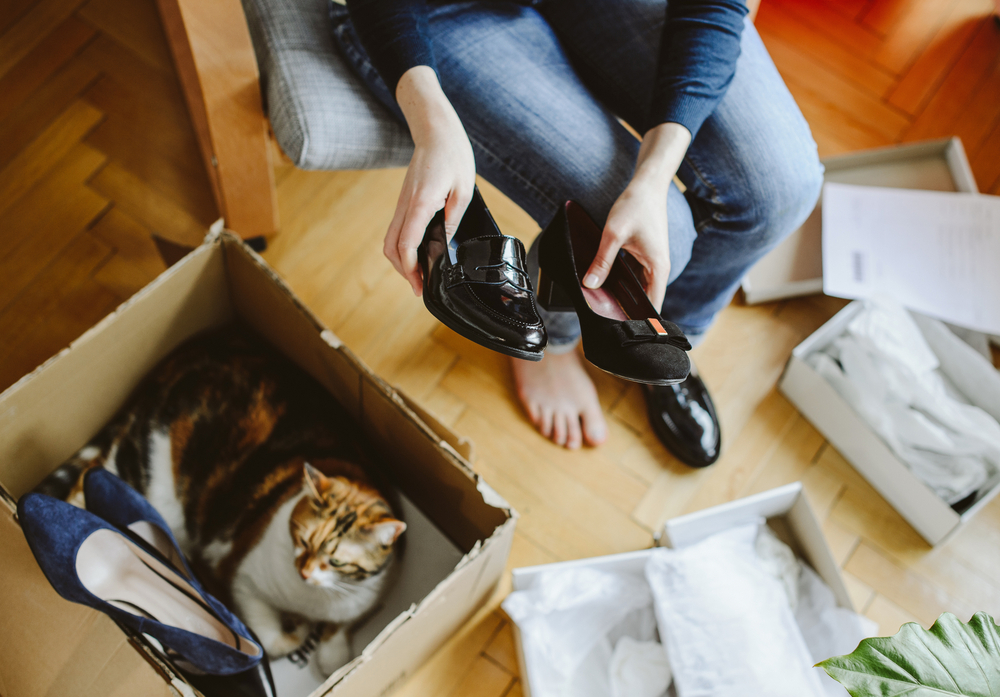 Фотографія жінка розпаковує коробки зі взуттям
