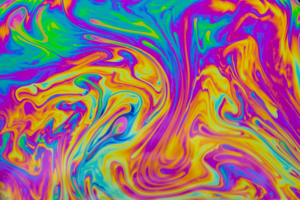 Psychedelic multicolored patterns background. Photo macro shot o