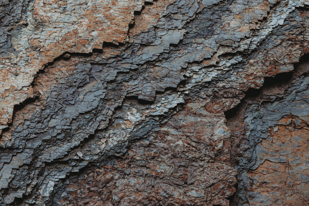 Dark rock texture with cracks