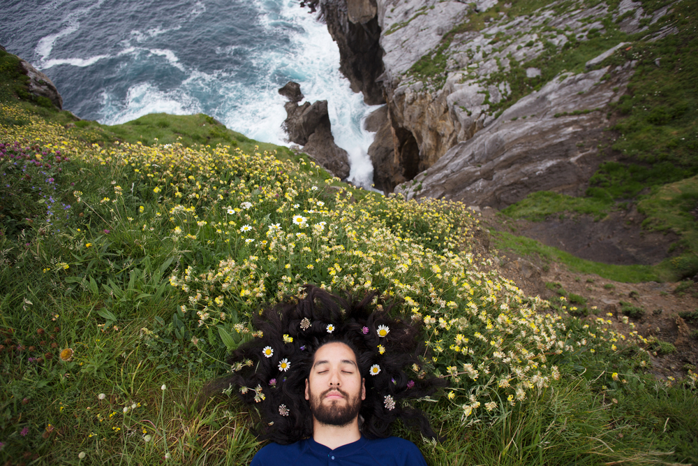 Overhead shot of bearded man with flowers in hair