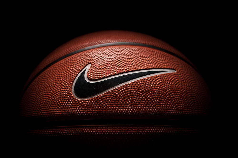 Photo Nike brand, basketball ball Nike Baller. Orange rubber outdoor ball, ultra-durable cover, close-up on a black background.